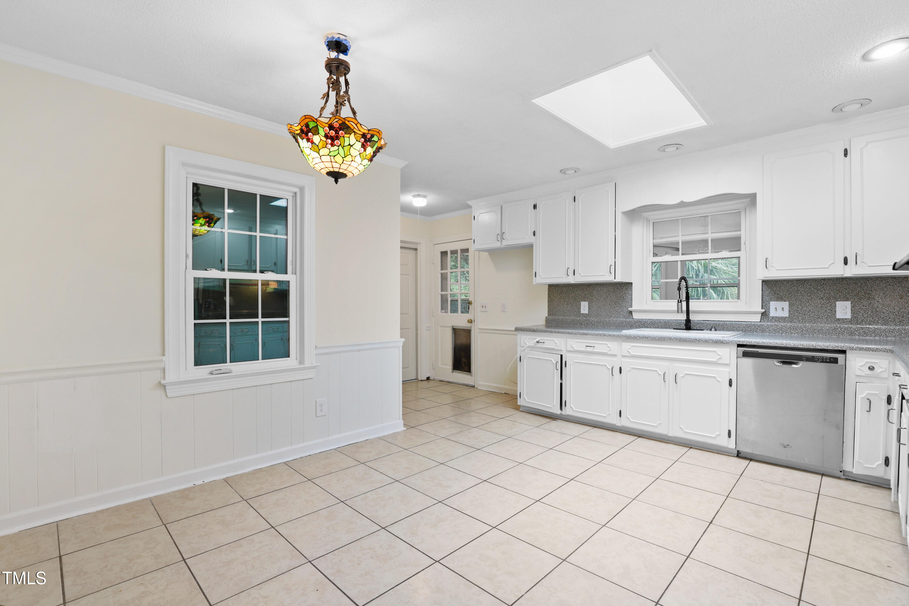 1204 Country Ridge Drive Raleigh, NC 27609 - Photo 3 of 49 a kitchen with a cabinets a stove a sink and a window