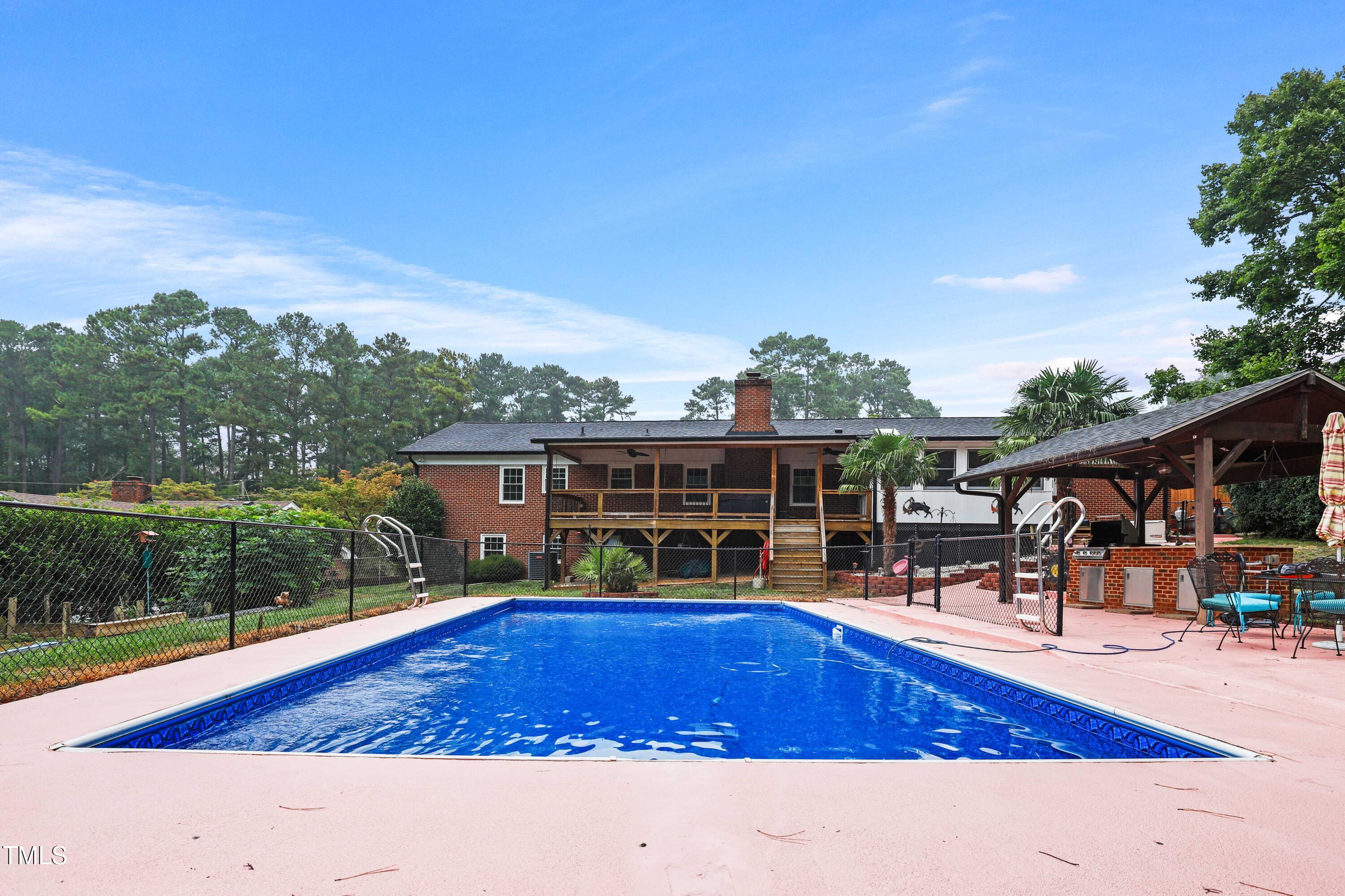 1204 Country Ridge Drive Raleigh, NC 27609 - Photo 35 of 49 a view of a house with pool and chairs