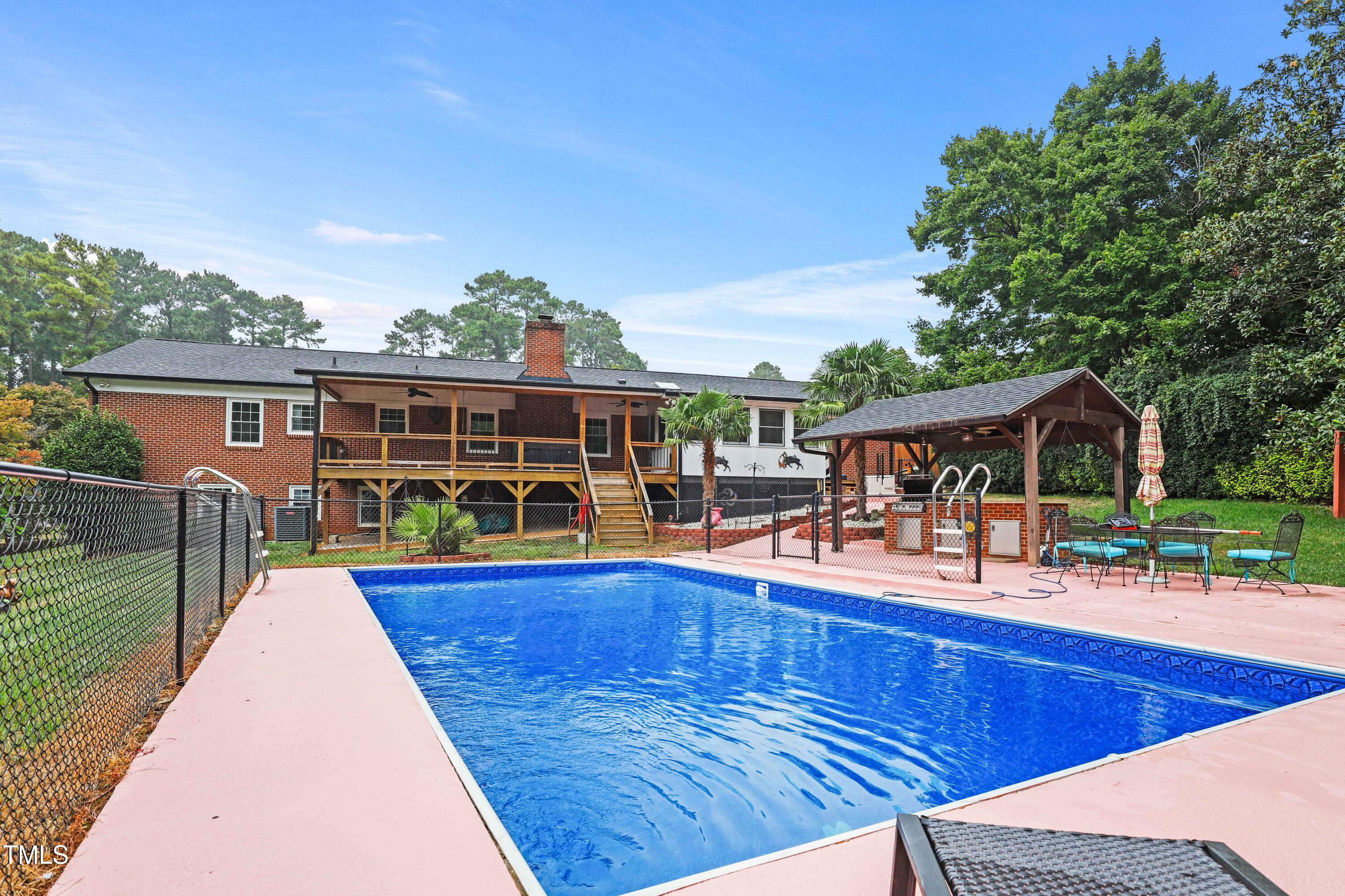 1204 Country Ridge Drive Raleigh, NC 27609 - Photo 36 of 49 swimming pool view with sitting space and garden view