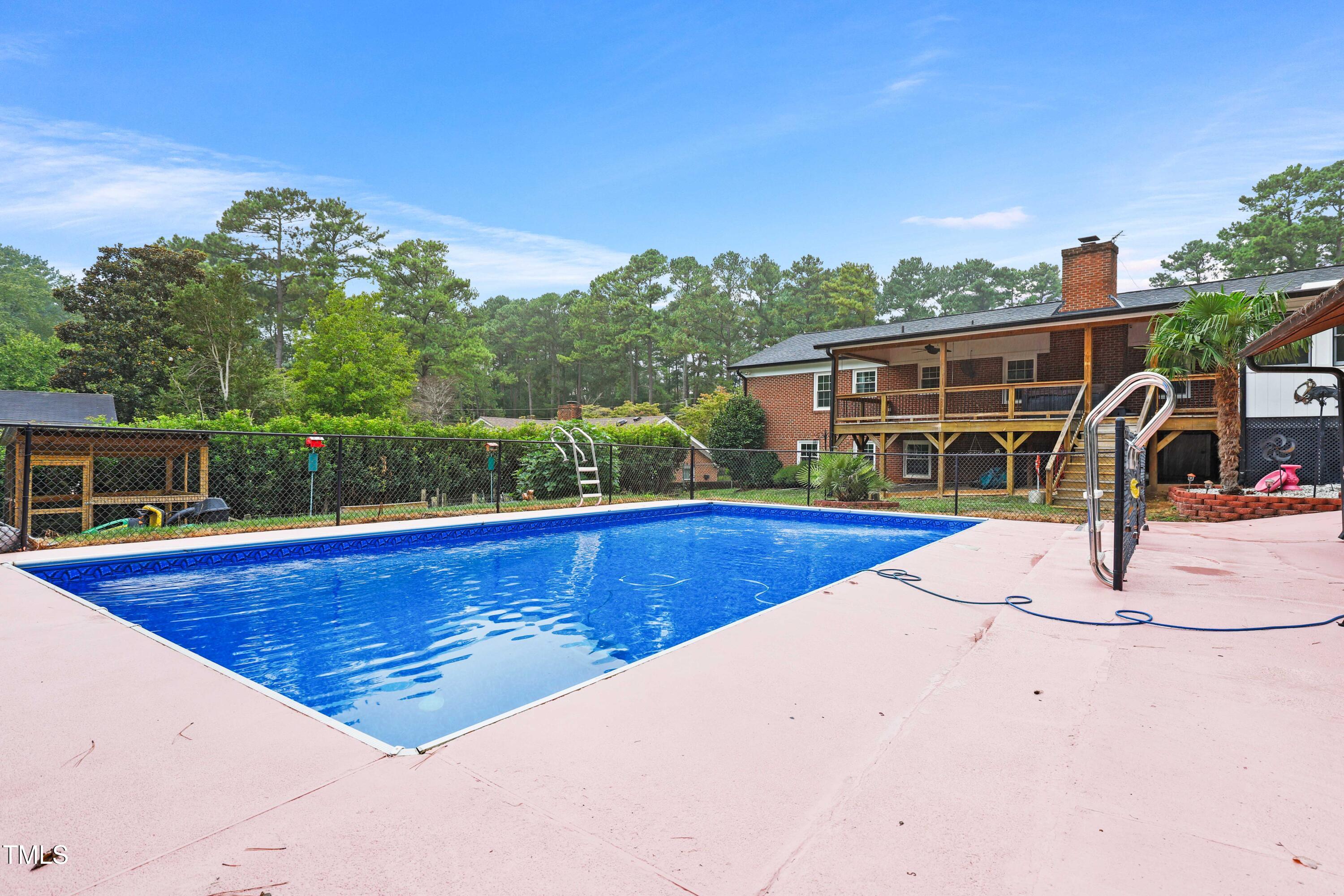 1204 Country Ridge Drive Raleigh, NC 27609 - Photo 37 of 49 a view of a swimming pool with a patio and a yard