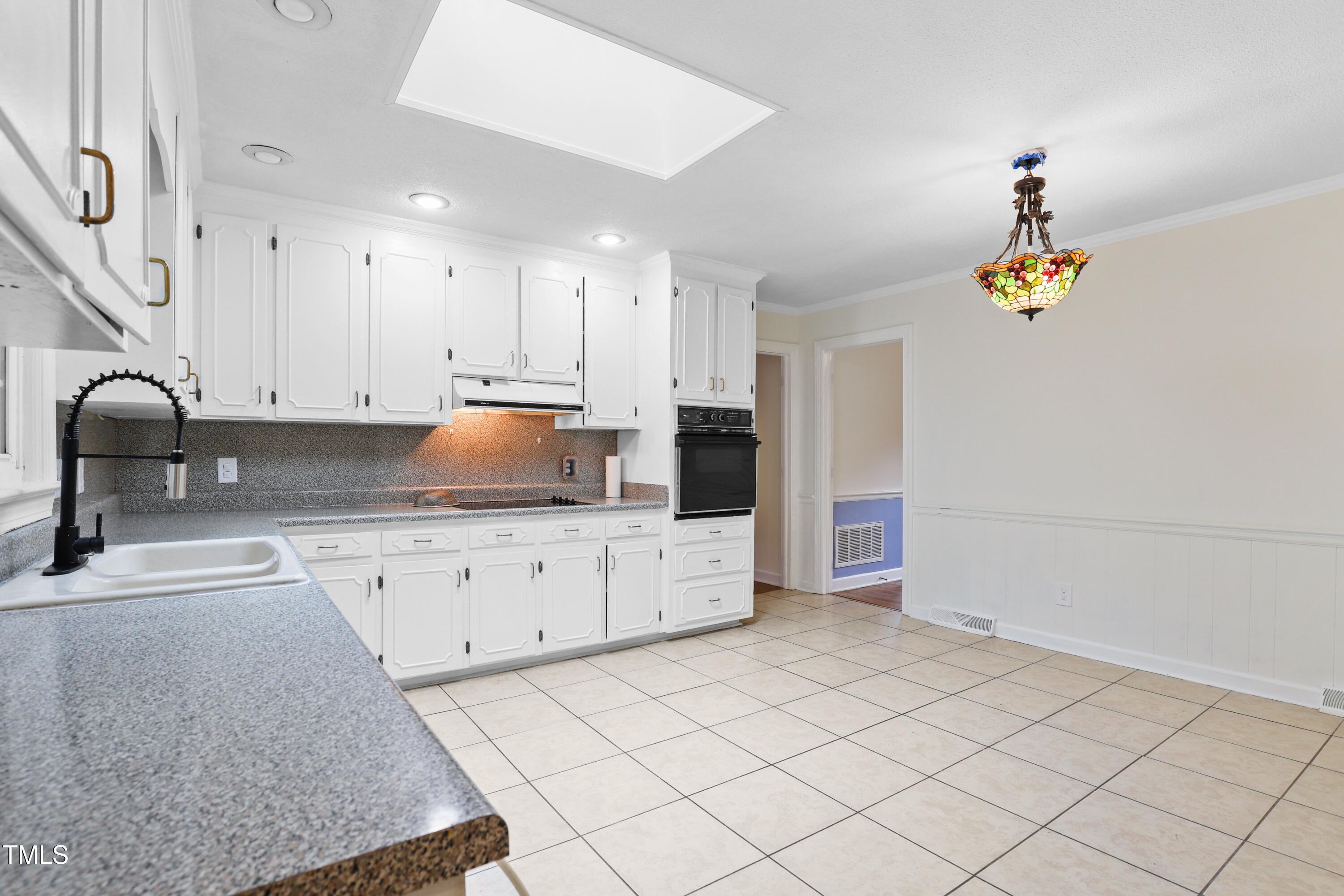 1204 Country Ridge Drive Raleigh, NC 27609 - Photo 4 of 49 a kitchen that has a lot of cabinets in it and wooden floors