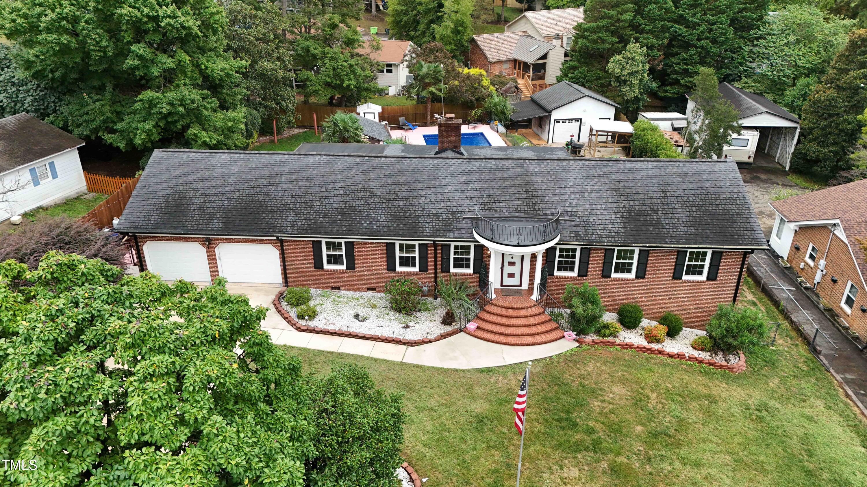 1204 Country Ridge Drive Raleigh, NC 27609 - Photo 48 of 49 an aerial view of a house with garden space and a patio