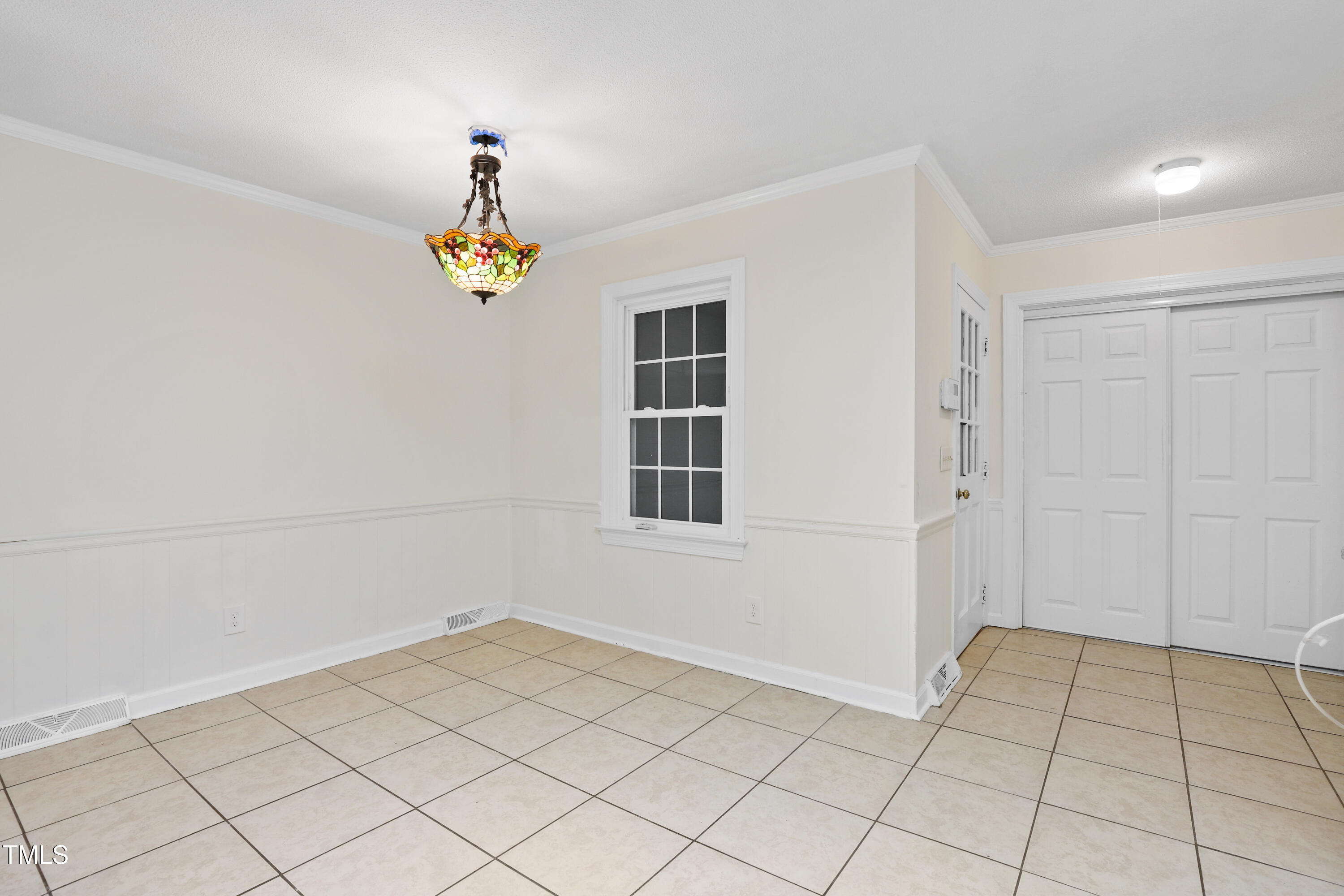 1204 Country Ridge Drive Raleigh, NC 27609 - Photo 6 of 49 a view of an empty room and window