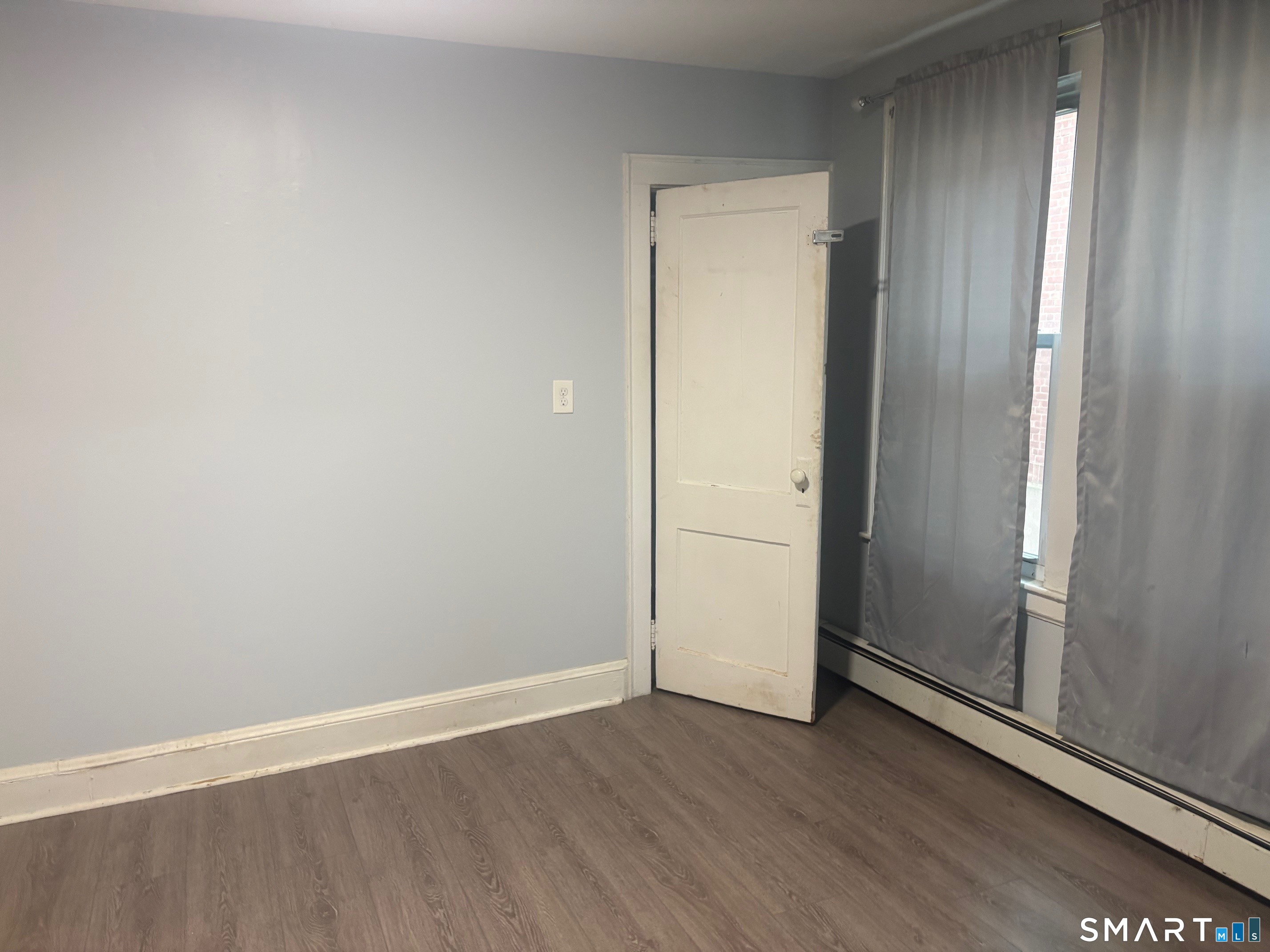 580 High Street Middletown, CT 06457 - Photo 10 of 11 an empty room with wooden floor and door