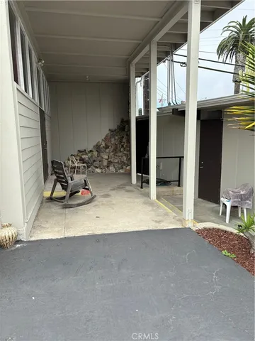 a view of a patio with table and chairs and potted plants