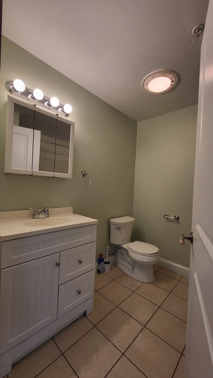 277 Pawtucket Street, Unit 2C Lowell, MA 01854 - Photo 6 of 16 a bathroom with a toilet sink and mirror
