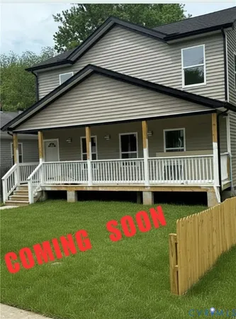 a view of backyard with deck and a garden