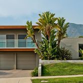 a house that has a tree in front of it