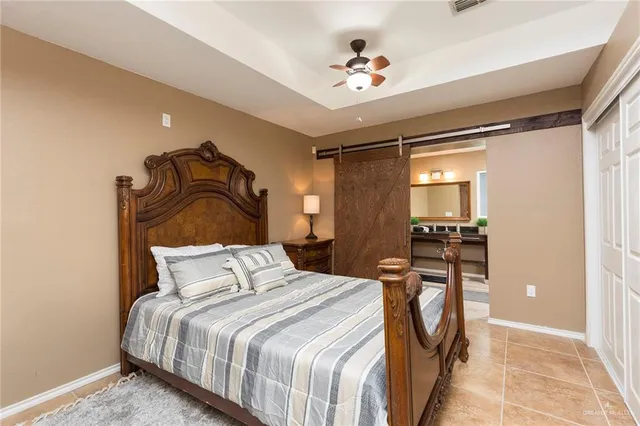 a bedroom with a bed and a chandelier