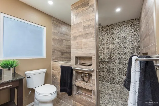 a bathroom with a toilet a sink and a shower