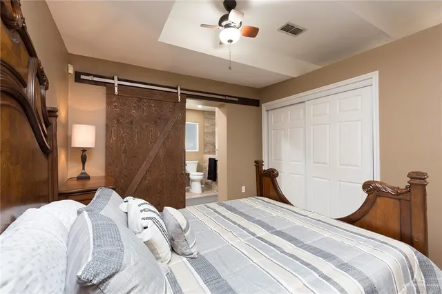 a bedroom with a bed and a chandelier