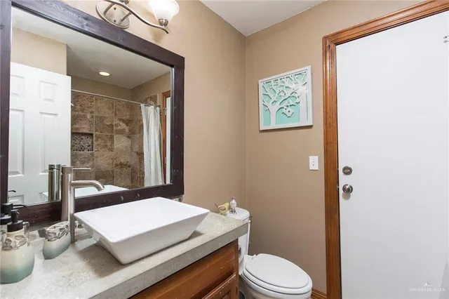 a bedroom with a bed couch and a window