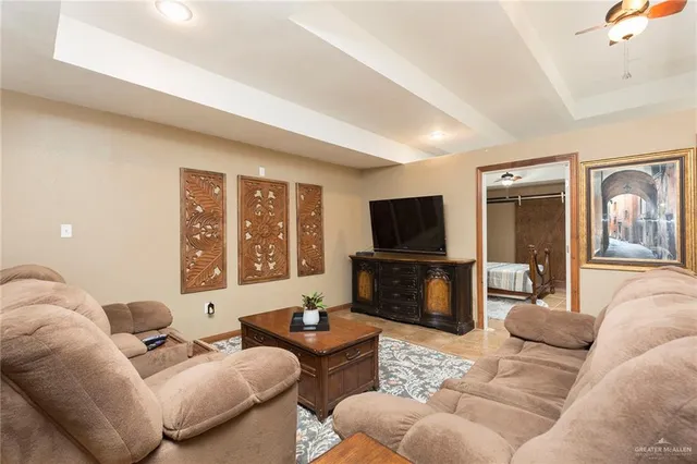 a living room with furniture flat screen tv and a large window