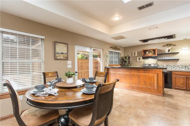 a dining room with furniture and window