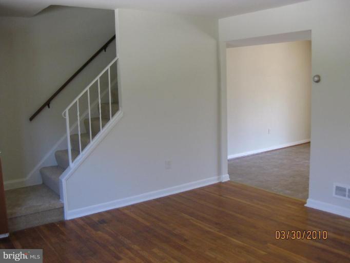 667 South Wickham Road Baltimore, MD 21229 - Photo 5 of 11 a view of an empty room with wooden floor