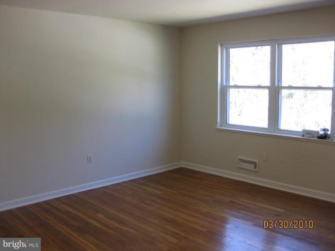 667 South Wickham Road Baltimore, MD 21229 - Photo 6 of 11 wooden floor and window in an empty room