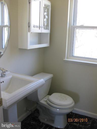 667 South Wickham Road Baltimore, MD 21229 - Photo 7 of 11 a bathroom with a sink and a toilet