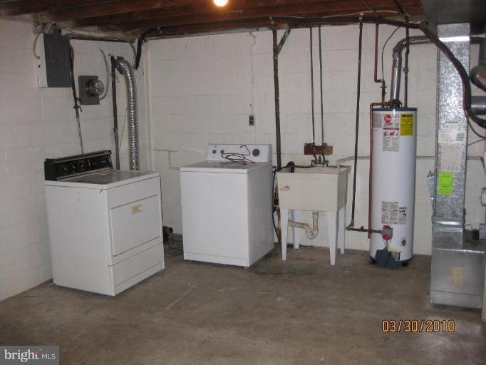 667 South Wickham Road Baltimore, MD 21229 - Photo 8 of 11 a view of a storage & utility room with washer and dryer