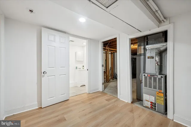 a view of empty room with wooden floor