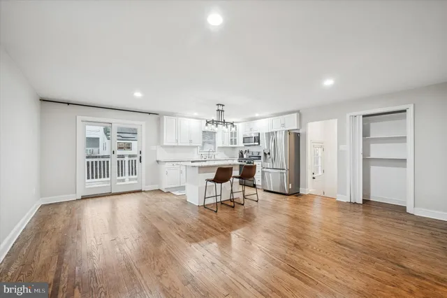 a view of a kitchen with furniture and wooden floor