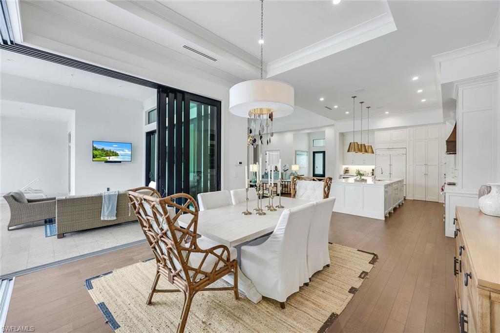3200 Crayton Road Naples, FL 34103 - Photo 12 of 30 a view of a dining room with furniture