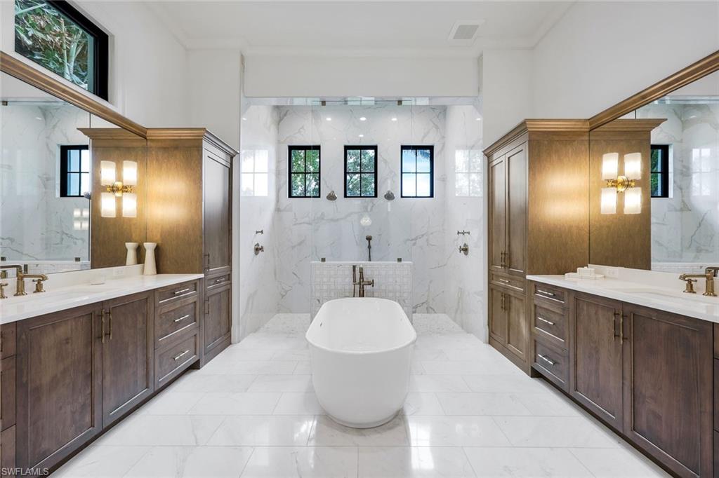 3200 Crayton Road Naples, FL 34103 - Photo 16 of 30 a spacious bathroom with a toilet sink and mirror