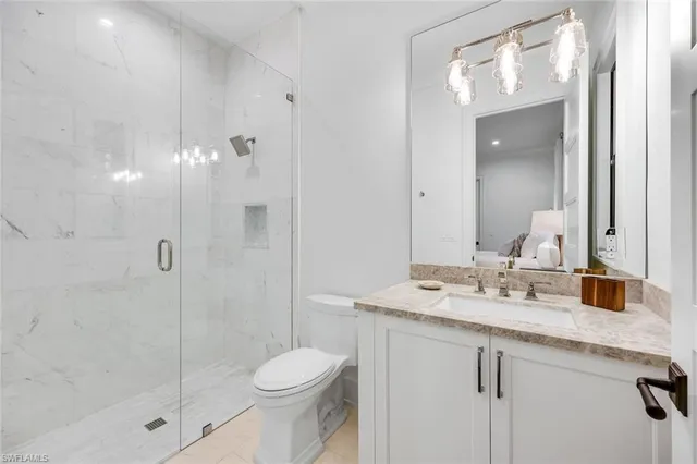 a spacious bedroom with a bed and a dresser