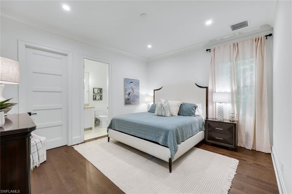 3200 Crayton Road Naples, FL 34103 - Photo 19 of 30 a spacious bedroom with a bed and a dresser