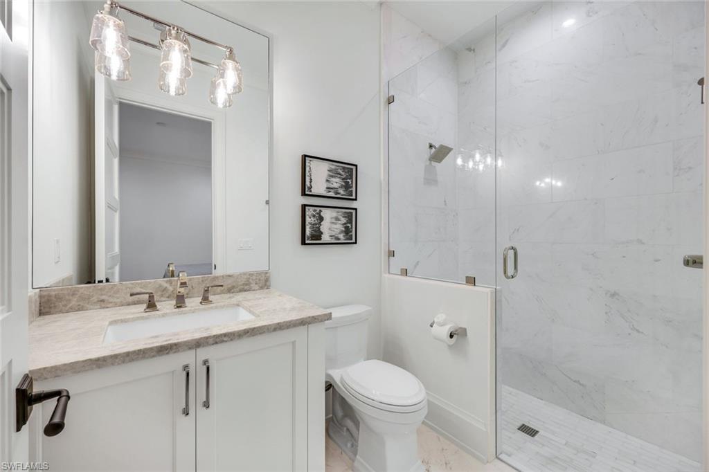 3200 Crayton Road Naples, FL 34103 - Photo 20 of 30 a bathroom with a sink a toilet and shower