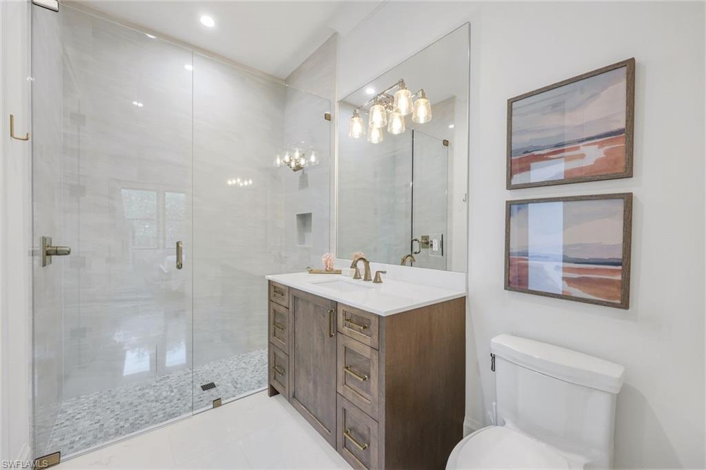 3200 Crayton Road Naples, FL 34103 - Photo 22 of 30 a bathroom with a sink a toilet and shower