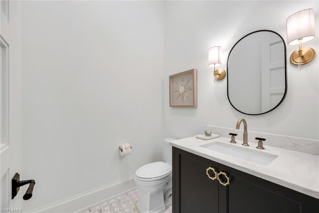3200 Crayton Road Naples, FL 34103 - Photo 24 of 30 a bathroom with a sink and a mirror