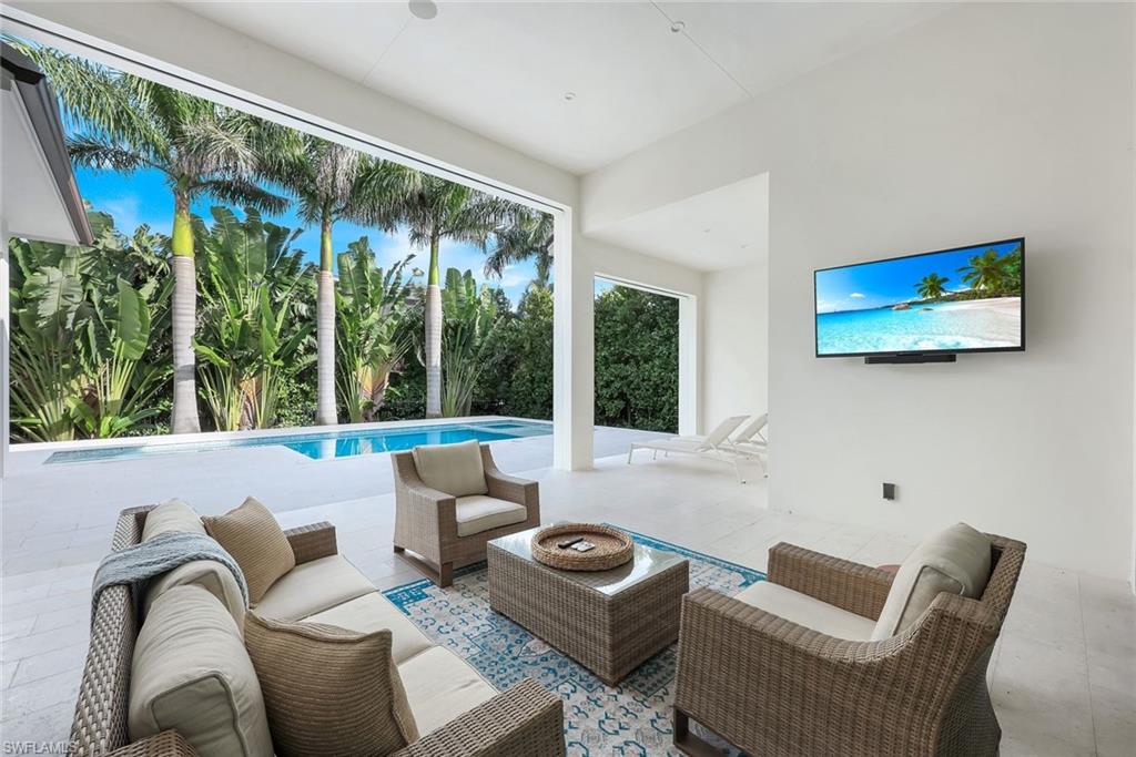 3200 Crayton Road Naples, FL 34103 - Photo 27 of 30 a living room with furniture and a large window