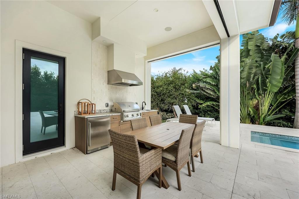 3200 Crayton Road Naples, FL 34103 - Photo 28 of 30 a dining room with furniture and window