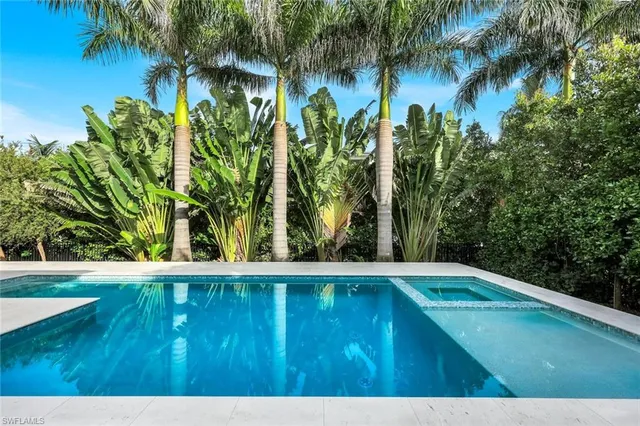 a view of a patio with swimming pool table and chairs