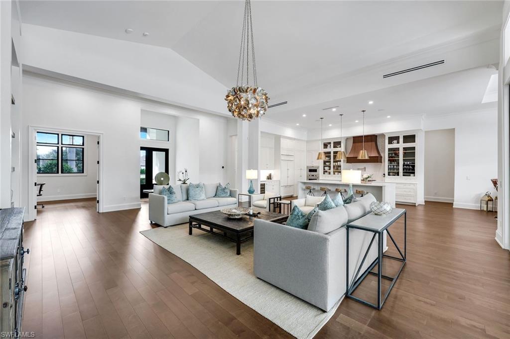 3200 Crayton Road Naples, FL 34103 - Photo 3 of 30 a living room with fireplace furniture and a wooden floor