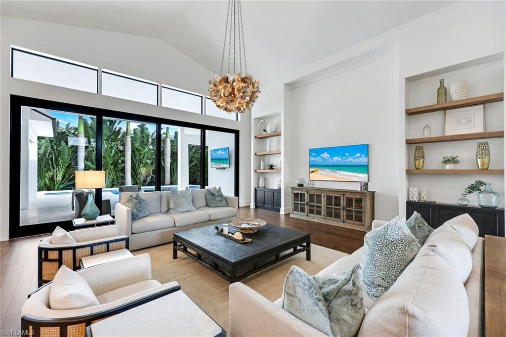 3200 Crayton Road Naples, FL 34103 - Photo 5 of 30 a living room with furniture and a large window