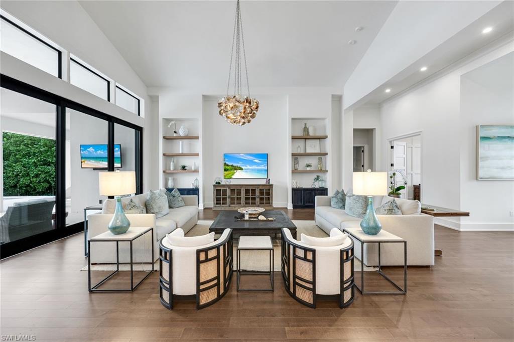 3200 Crayton Road Naples, FL 34103 - Photo 6 of 30 a living room with fireplace furniture and a large window