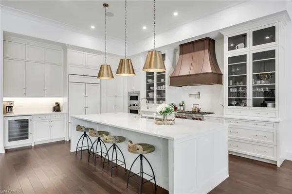 a large kitchen with a table and chairs