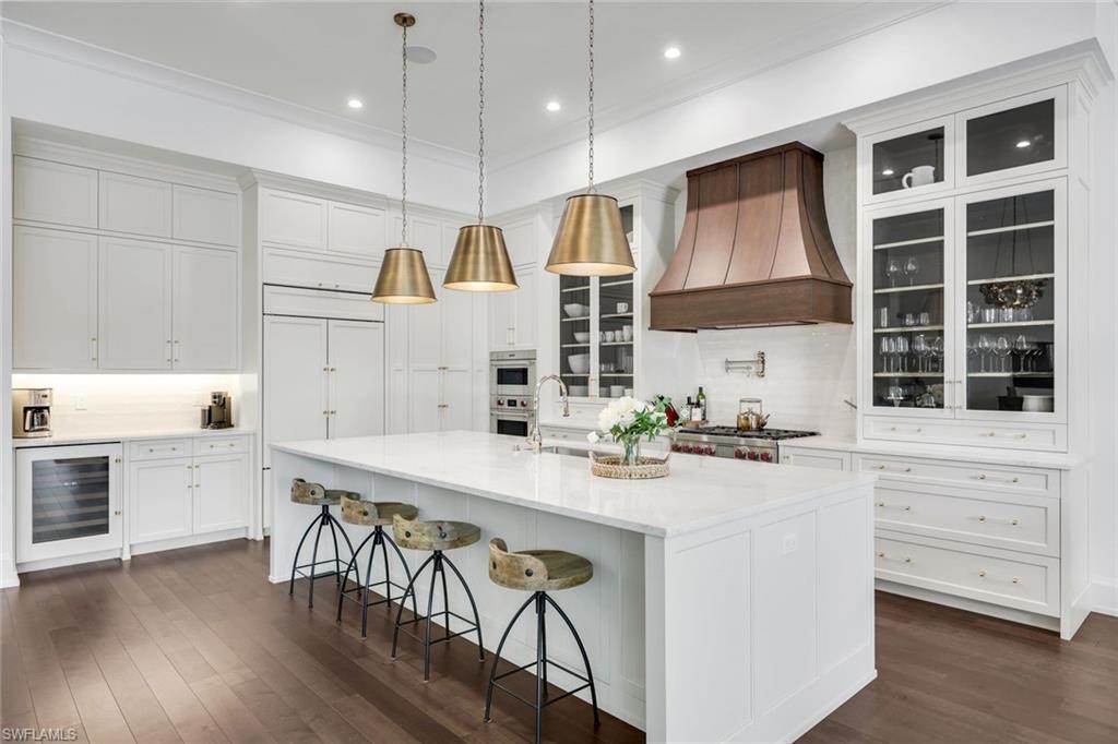 3200 Crayton Road Naples, FL 34103 - Photo 7 of 30 a kitchen with a stove a sink and a refrigerator