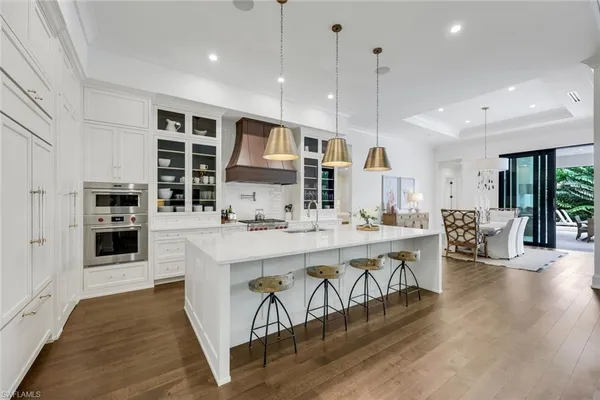 a large kitchen with stainless steel appliances kitchen island granite countertop a large island in the center