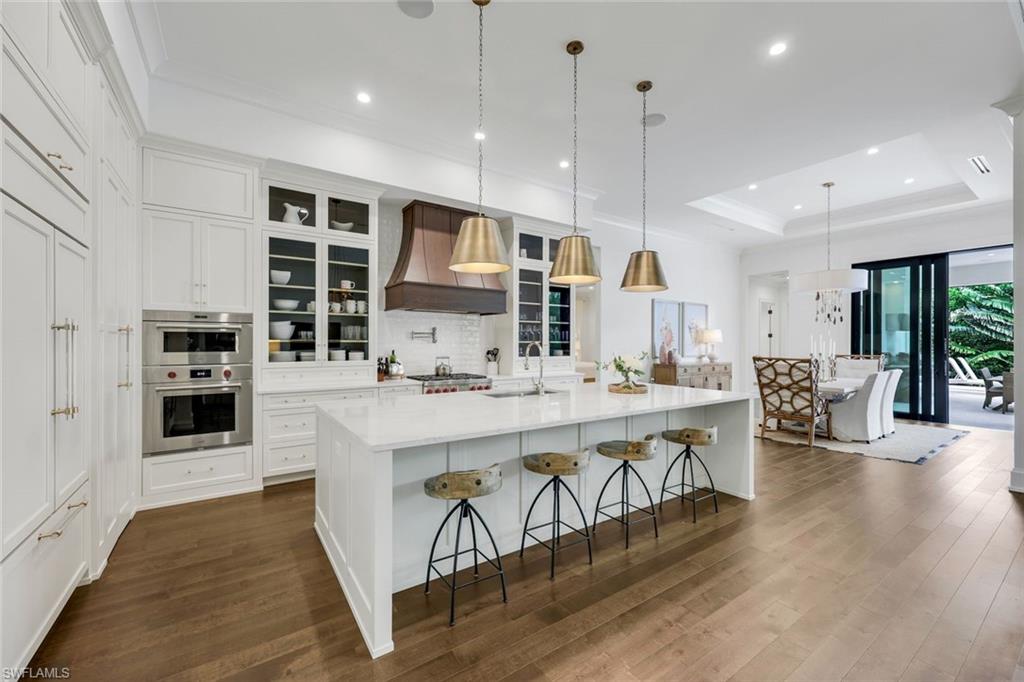 3200 Crayton Road Naples, FL 34103 - Photo 8 of 30 a large kitchen with a table and chairs