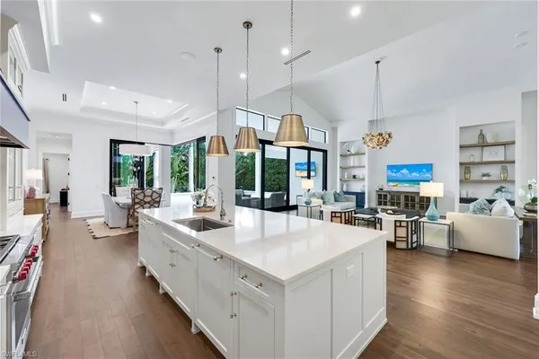 a kitchen with cabinets table and chairs