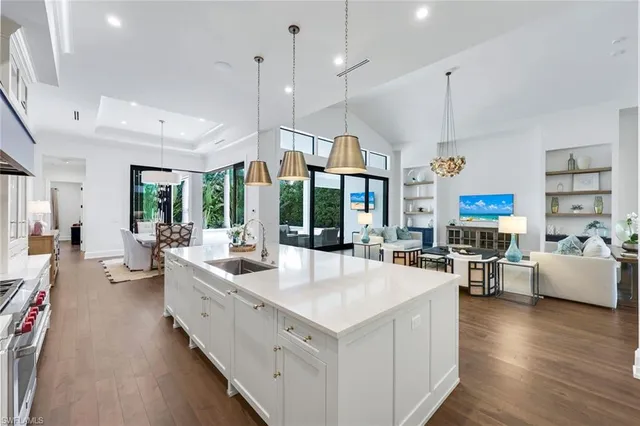a kitchen with cabinets table and chairs