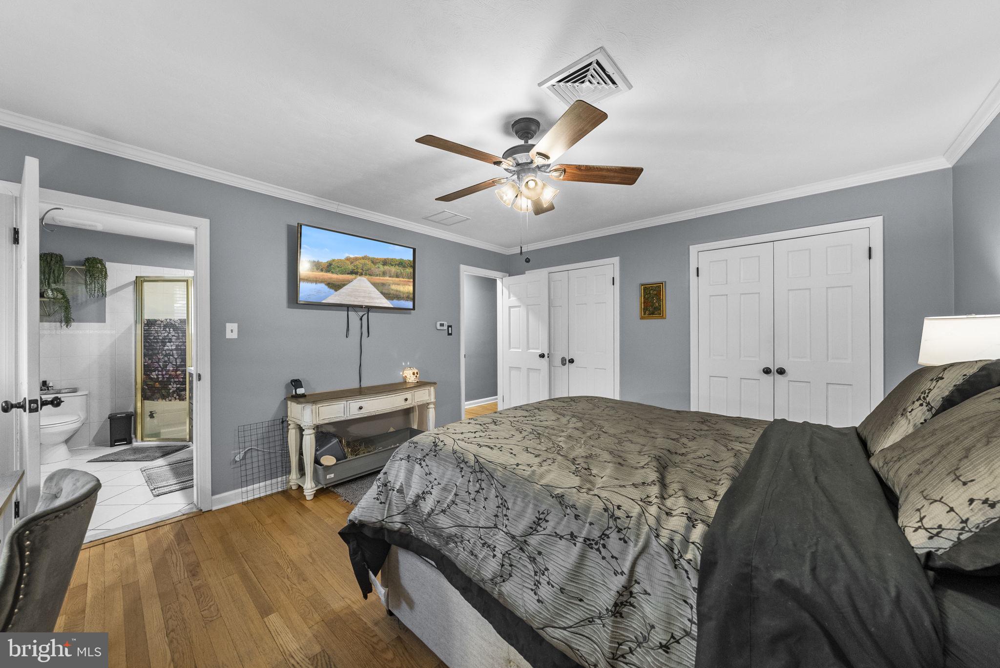 247 Washington Crossing Pennington Road Titusville, NJ 08560 - Photo 37 of 53 a bedroom with a bed and a chandelier