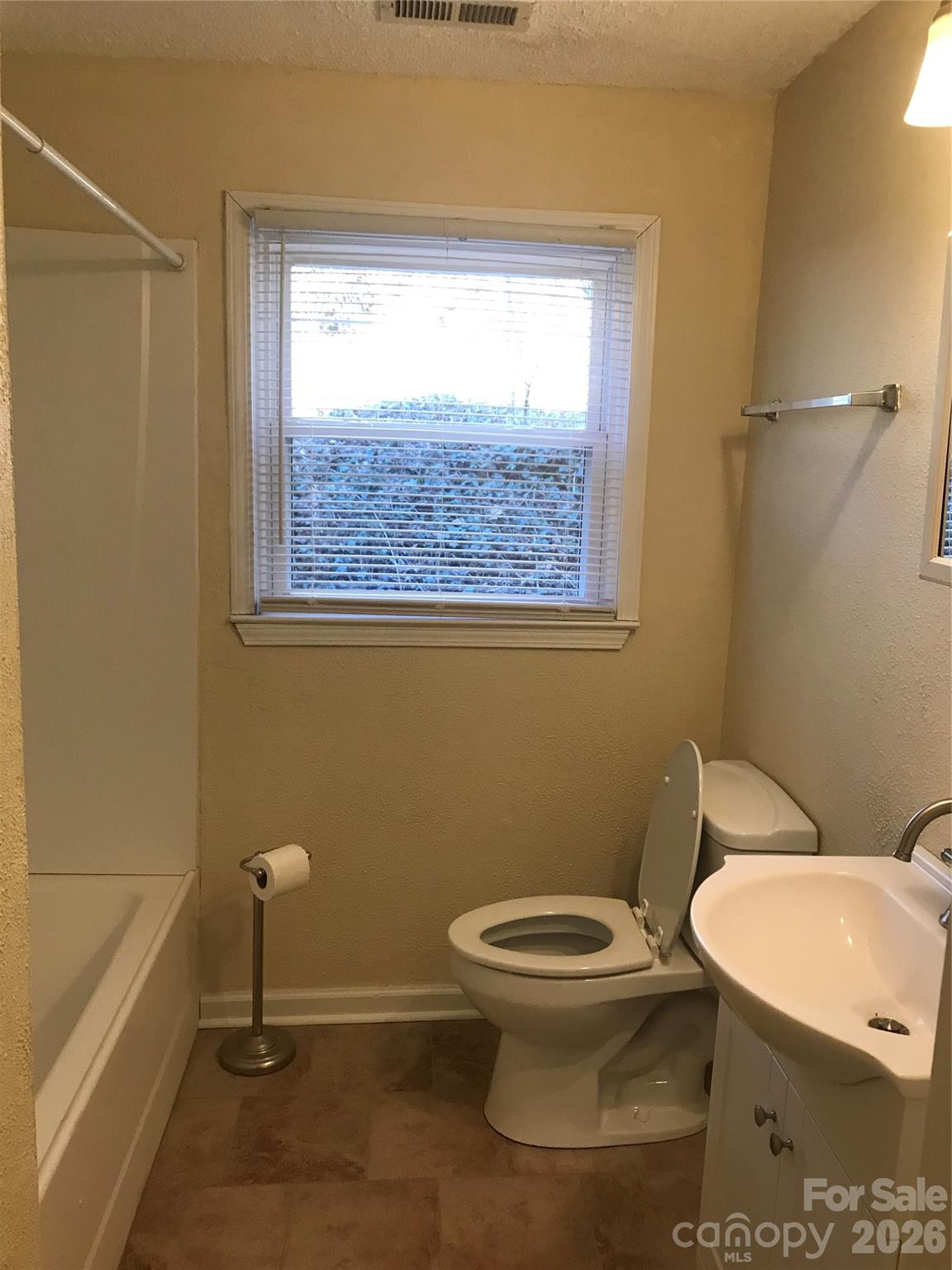 545 Avery Creek Road Arden, NC 28704 - Photo 14 of 35 a white toilet sitting next to a window in a bathroom