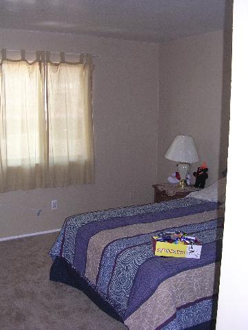 2555 Clear Acre Lane, Unit 731 Reno, NV 89512 - Photo 4 of 4 a bed sitting in a bedroom next to a window
