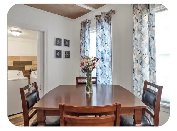 a view of a dining room with furniture and chandelier
