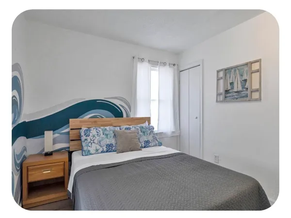 a bedroom with a bed and a table in it