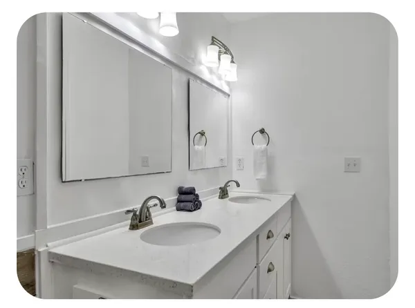 a bathroom with a sink toilet and mirror