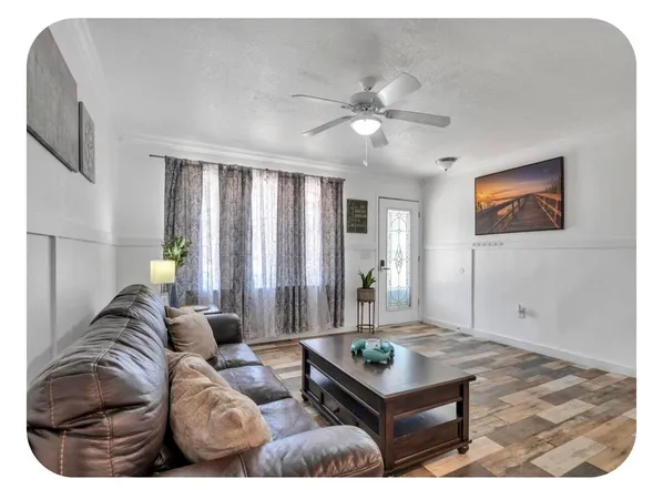 a living room with furniture and a chandelier